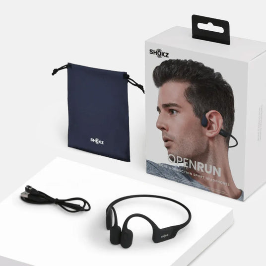 Shokz OpenRun headphones with packaging, cable, and pouch on a white background